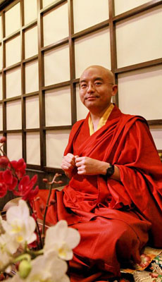 Mingyur Rinpoche in front of flowers